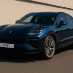 Luxurious blue Porsche Macan EV parked on a clean asphalt road in daylight, showcasing its sleek design and electric vehicle features.