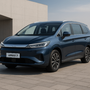 BYD eMAX 7 electric MPV in metallic blue color parked on modern stone pavement in front of minimalistic building.